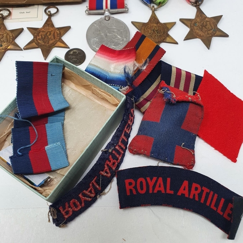 153 - Four WWII Stars, a War Medal, assorted patches and other items