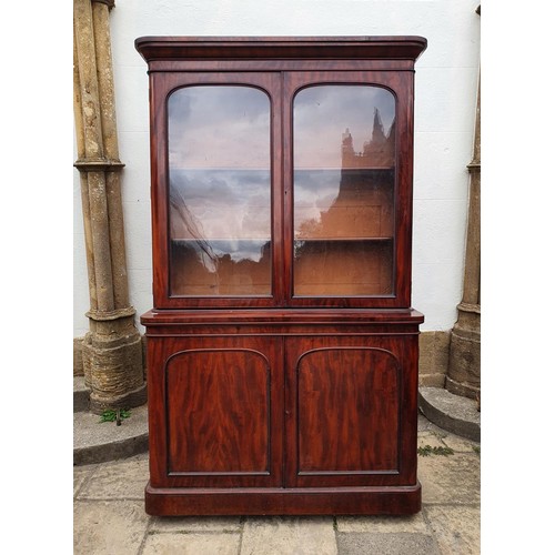 912 - A 19th century mahogany bookcase on cabinet, 138 cm wide