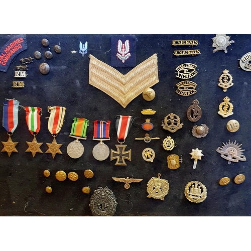 143 - A group of British and German badges and awards, including an iron cross, mounted on a board