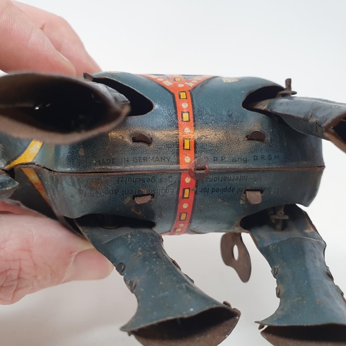 232 - An early 20th century clockwork Jumbo toy, and a clockwork bird toy (2)