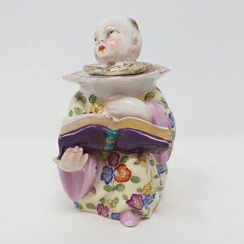 503A - A 19th century Dresden novelty bottle, of a young boy reading a book, 9 cm high