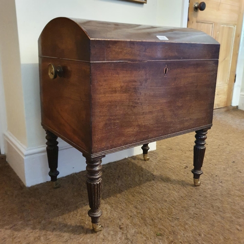 176 - A 19th century mahogany wine cellarette, the domed top inlaid with a shell, on turned and reeded leg... 