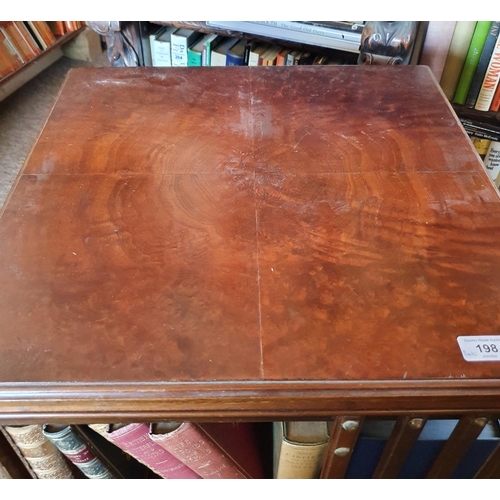 193 - A revolving bookcase, veneered in walnut, 50 cm wide