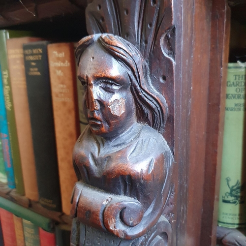 194 - A late Victorian oak breakfront bookcase, carved figures and foliage in high relief, 183 cm wide x 1... 