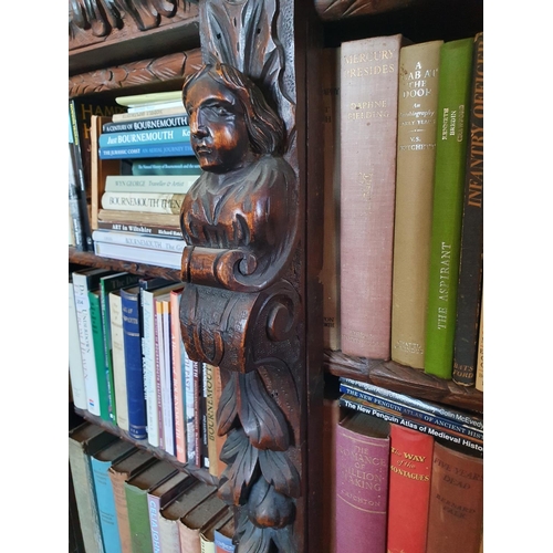 194 - A late Victorian oak breakfront bookcase, carved figures and foliage in high relief, 183 cm wide x 1... 