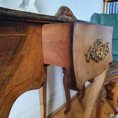 217 - A Louis XVI style walnut table, of serpentine outline, having a frieze drawer, on cabriole legs, 62 ... 