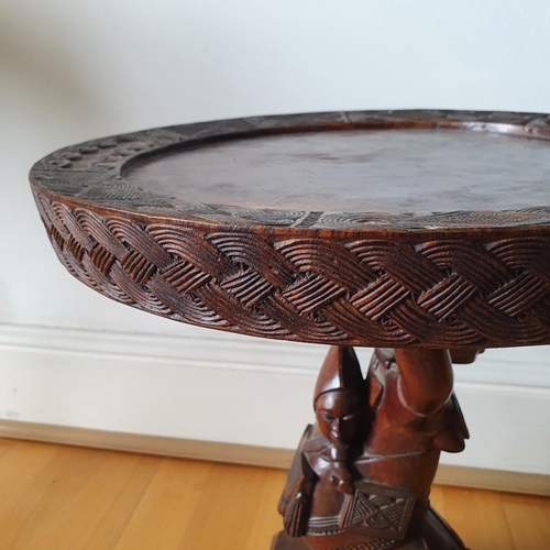 221 - An African low table, on a carved figural support, 45 cm high