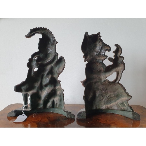 224 - A cast metal and painted Mr Punch doorstop, 31 cm high, and another, Mrs Punch, 29 cm high (2)