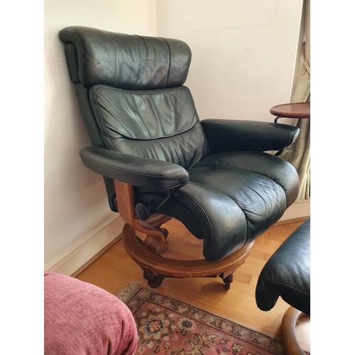 236 - A Stressless style leather upholstered armchair, with a matching stool