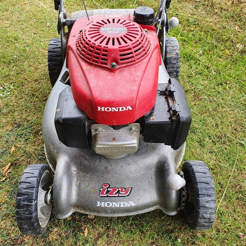 24 - A Honda Izy petrol lawn mower (in the garden shed)...