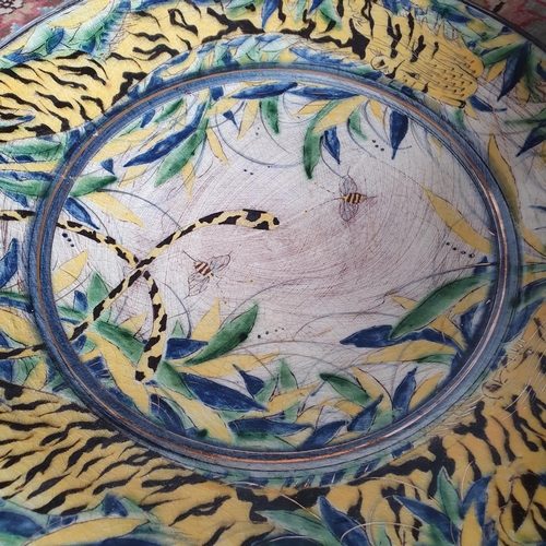 246 - A modern pottery charger, decorated bees and foliage, 38 cm diameter