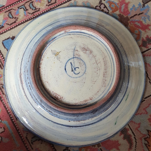 246 - A modern pottery charger, decorated bees and foliage, 38 cm diameter