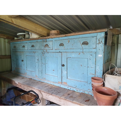 26 - A late Victorian stripped pine and blue painted kitchen dresser, the two tier plate rack above a bas...