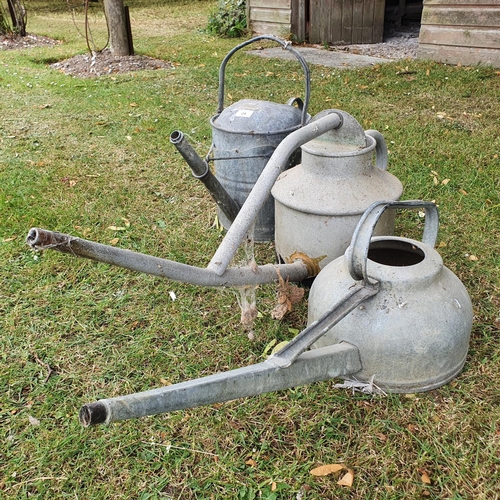 29 - A galvanised metal two gallon watering can, and two others (in the garden shed)...