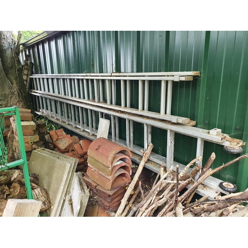 35 - A green painted log holder, a galvanised metal post whacker, and the two ladders attached to the bac...