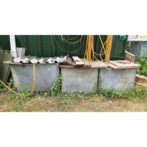 37 - A galvanised metal cystern, 90 cm wide, and two others similar (currently full of water)...