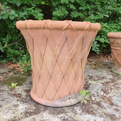 41 - A pair of terracotta garden pots, with lattice work style decoration, approx. 56 cm high...