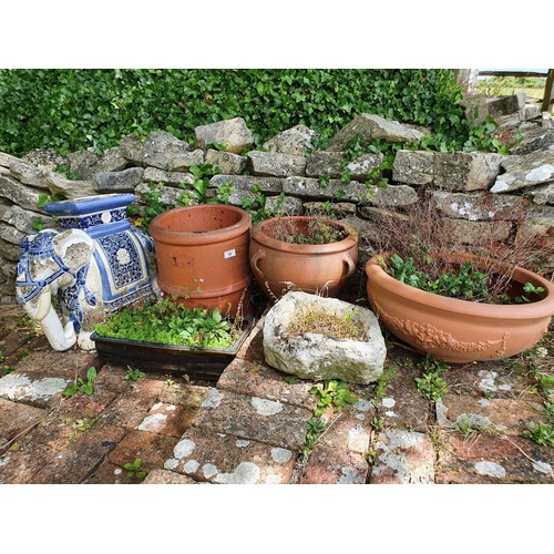 48 - A small garden trough, of irregular form, 28 cm wide, four other pots, one without a base, and an el...
