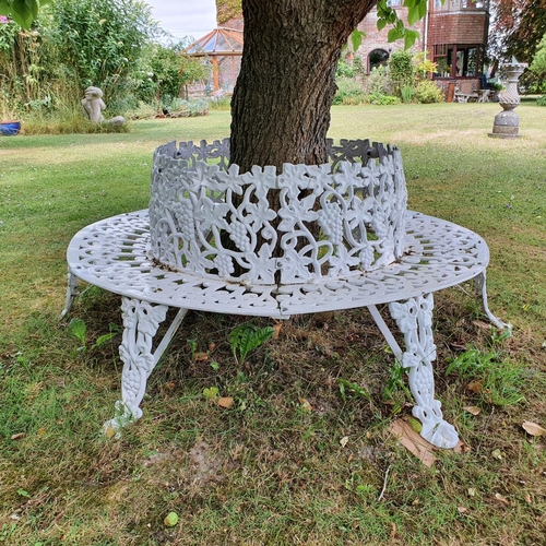 51 - A Victorian style painted cast metal tree bench, decorated grapes and foliage...