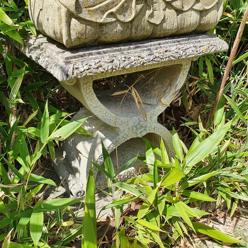 63 - A reconstituted stone figure, of a seated buddha, on a stand, approx. 98 cm high