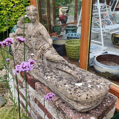 64 - A reconstituted stone figure, of a reclining maiden, approx. 91 cm wide