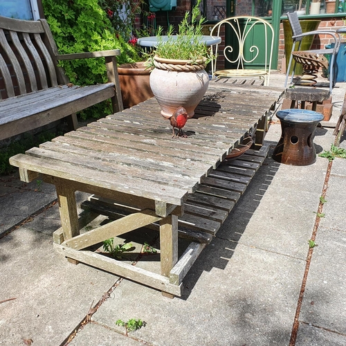 85 - A tractor seat, mounted on a spring, two garden chairs, a garden low table, assorted garden pots and... 