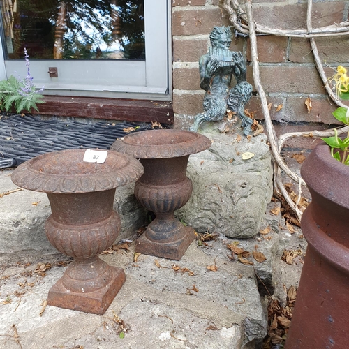 87 - A small pair of cast iron garden urns, 22 cm high, and a bronze figure of Pan, mounted on a base, ap... 