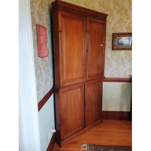 274 - A mahogany floor standing corner cupboard, having two pairs of panel doors, approx. 108 cm wide