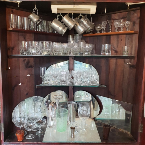 275 - A large quantity of assorted glass, contained in the floor standing corner cupboard