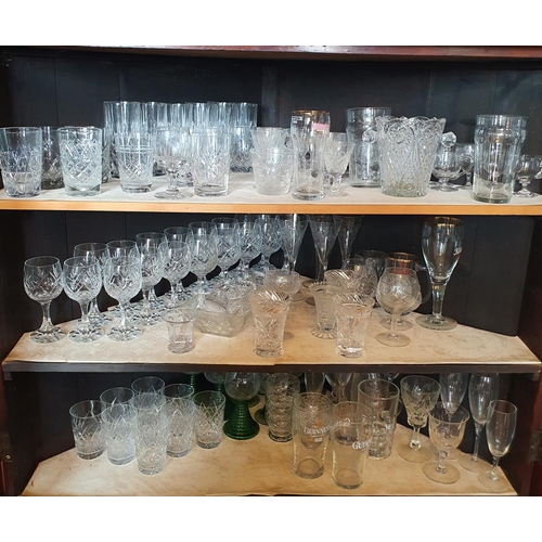 275 - A large quantity of assorted glass, contained in the floor standing corner cupboard