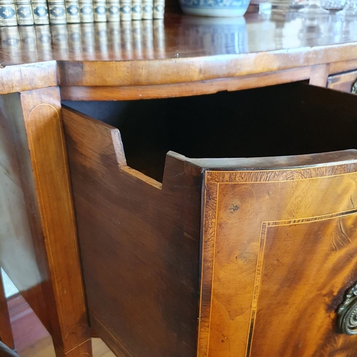 277 - A 19th century inlaid mahogany sideboard, with a bow front central section having three drawers, on ... 