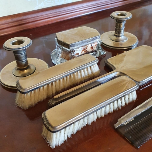 292 - A silver and enamel part dressing table set, including a pair of candlesticks, Birmingham 1947