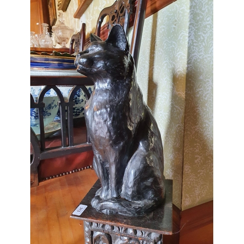 313 - A bronzed figure of a seated cat, 40.5 cm high, on a plinth base, 73 cm high (overall)