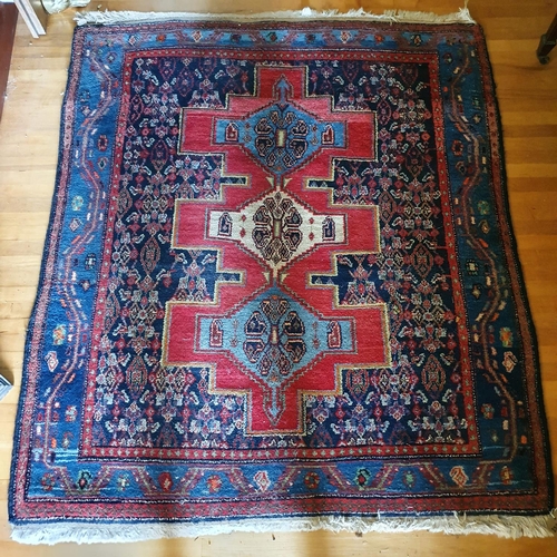 319 - A small Persian style rug, with three central lozenges, 150 x 133 cm