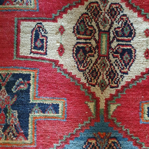 319 - A small Persian style rug, with three central lozenges, 150 x 133 cm