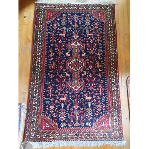 320 - A small Persian rug, with a central lozenge on a salmon pink ground, 145 x 70 cm, and another simila... 