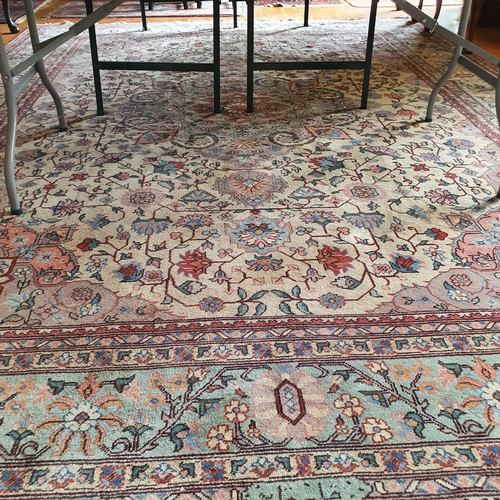 321 - A Persian style carpet, the central ground decorated scrolling foliage, 277 x 363 cm