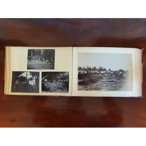 328 - A late 19th/early 20th century photograph album, including topographical views, and African cricket ... 