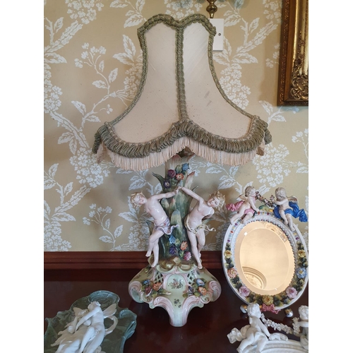 338 - A late 19th century Dresden type porcelain strut mirror, mounted with cherubs and flowers, some dama... 