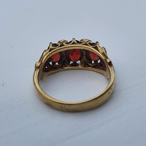 346 - A 9ct gold and garnet three stone ring