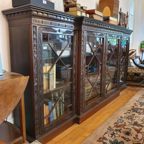 358 - A late Victorian S & H Jewell breakfront mahogany bookcase, carved scrolling foliage and bell flower... 