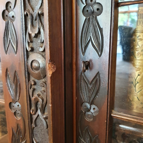 358 - A late Victorian S & H Jewell breakfront mahogany bookcase, carved scrolling foliage and bell flower... 