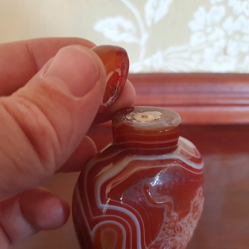 389 - A Chinese agate snuff bottle and stopper, carved a mountain scene, 9 cm high, stopper detached