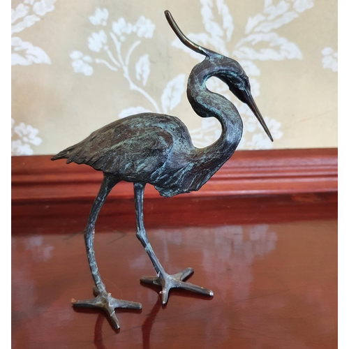 391 - A Michael Story bronze figure of a crane or heron bird, 16 cm high