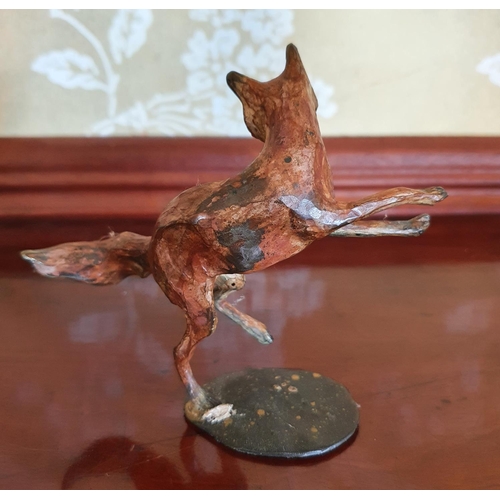 392 - A Michael Story bronze figure of a jumping fox, 11 cm high