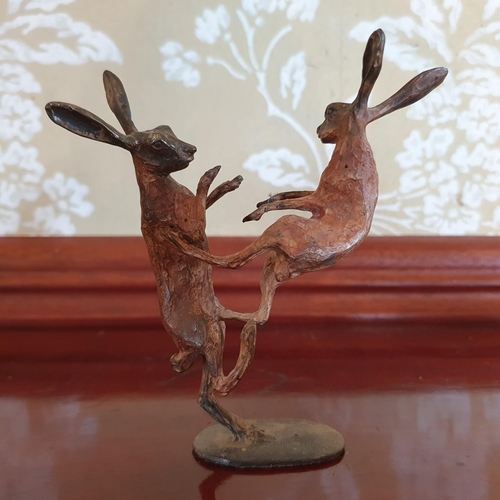 394 - A Michael Story bronze group, of two boxing hares, 12 cm high