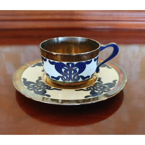 397 - A M. Hammer silver coloured metal and enamel cup and saucer