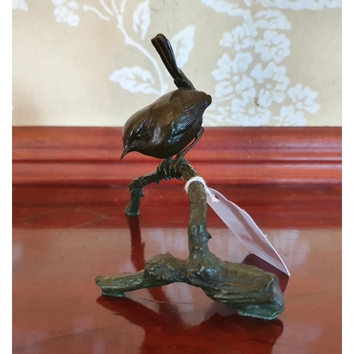 412 - A bronze figure of a Wren perched on a branch, in the manner of Pat Northcroft, 10 cm high