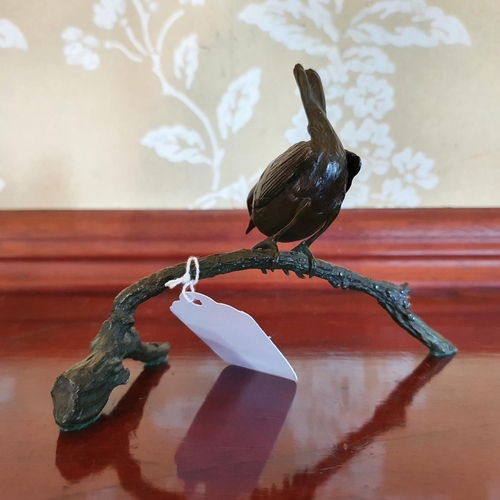 412 - A bronze figure of a Wren perched on a branch, in the manner of Pat Northcroft, 10 cm high