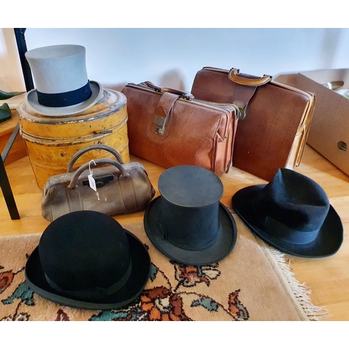 417 - A top hat box, three hats, two suitcases and a small doctor's type bag